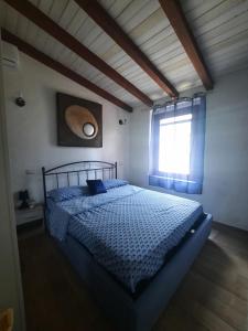 a bedroom with a bed and a window at Villa Tiziana in Costa Rei