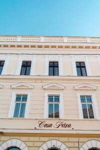 a building with windows and a sign on it at Casa Petra in Sibiu