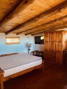 a bedroom with a bed and a wooden ceiling at Quinta,MI TROZO DE CIELO in La Porteña