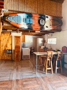 a room with a table and a boat on the ceiling at Quinta,MI TROZO DE CIELO in La Porteña