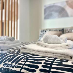 a pile of towels sitting on top of a bed at Lucia's House in San Giovanni Rotondo