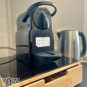 a tea kettle is sitting on a glass table at Lucia's House in San Giovanni Rotondo