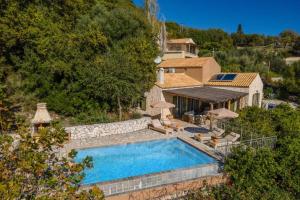 an external view of a villa with a swimming pool at Villa Ifandis by Villa Plus in Ratzaklíon