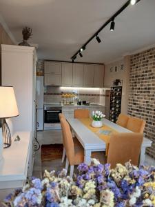 a kitchen and dining room with a table and chairs at House Hill Star Kumbor in Kumbor