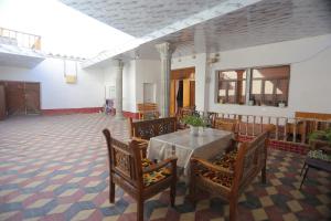 a dining room with a table and chairs at Musobek Guest House in Khiva