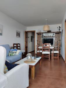 a living room with a couch and a table at Doña Carmen Playa Boutique in Suances +34 photos