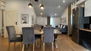 a kitchen and dining room with a table and chairs at Άνετο και πολυτελές οροφοδιαμέρισμα 2 in Chania Town