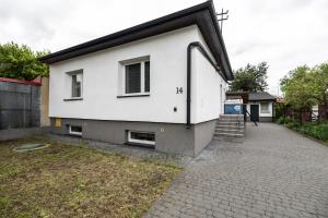 a white house with a window and stairs on it at Hostel ŚLISKA in Lublin