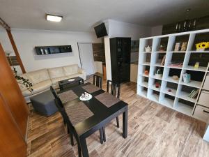a living room with a table and a couch at Apartmán Lovča in Lovča