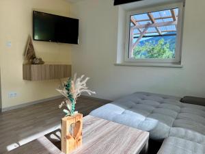 a living room with a couch and a window at Tyrolyl - Ferienhaus Tirol in Inzing