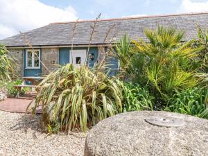 a house with a garden in front of it at Rose's Stable in Truro