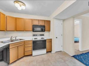 a kitchen with a sink and a microwave at Property near to Airport and Free Parking in Ascalon +1 photo