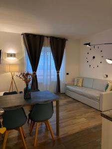 a living room with a couch and a table at La casa del capitano in Levanto +8 photos