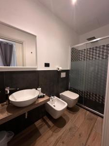 a bathroom with a sink and a toilet and a mirror at La casa del capitano in Levanto