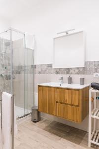 a bathroom with a sink and a shower at Serenello Home in Palermo +22 photos