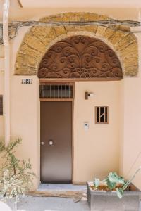an entrance to a building with a brown door at Serenello Home in Palermo