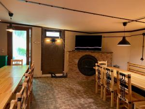 a room with a fireplace and a table and chairs at Stara Plynarna in Hřensko