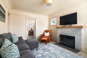 a living room with a couch and a fireplace at Cozy Ocean Beach Bungalow in San Diego