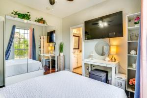 a bedroom with a bed and a desk and a tv at Explore and Unwind Charming Bedford Apartment in Bedford