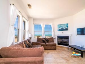 a living room with a couch and a fireplace at 3-Bedroom El Dorado Ranch San Felipe Rental with Beach View in Playa El Paraíso