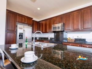 a kitchen with wooden cabinets and a granite counter top at 3-Bedroom El Dorado Ranch San Felipe Rental with Beach View in Playa El Paraíso