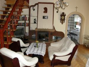 a living room with a table and chairs and a fireplace at Dom z Ogrodem Darłowo do 10 osób ! in Darłowo