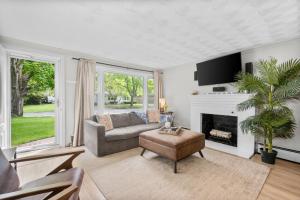 a living room with a couch and a fireplace at 7 Raymond Avenue South Yarmouth -The Sandlot Shanty in South Yarmouth