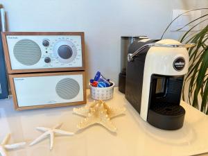 a counter with a coffee maker and a toaster and starfish at Villa Luminosa in Torre del Lago Puccini
