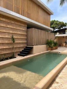 a swimming pool in front of a house at Jiloo Beautiful Retreat in Punta Zicatela 8 in Brisas de Zicatela