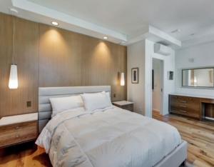 a bedroom with a large bed and a television at Elevated Living in the Hills in Portland