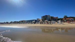 a beach with chairs and umbrellas on the sand at Villa Mirella in Villalfonsina