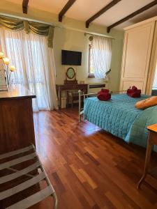 a bedroom with a bed and a desk and a television at Casetta Romana Alloggio Turistico in Borghesiana  +40 photos