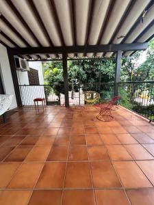 a screened in porch with a table and chairs at Casa MK in Ijuí