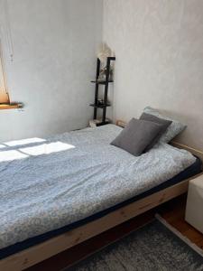 a bedroom with a bed with a blue comforter at Freshly renovated bathroom! Luna budget cozy studio apartment Tallinn Juhkentali 42 near city centre airport next to the Bus station in Tallinn