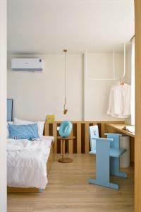 a bedroom with a bed and a desk and a chair at Vibrate Stay in Ho Chi Minh City