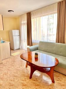 a living room with a coffee table and a couch at Vila Victoria Primorsko in Primorsko +19 photos