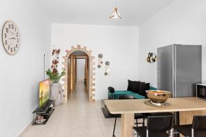 a living room with a table and a refrigerator at Malona Nostalgia in Malona Village