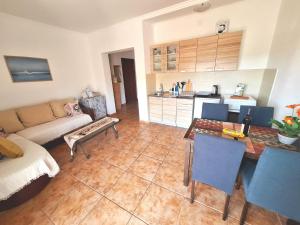 a living room with a couch and a table at Sea Whisper Apartment in Budva