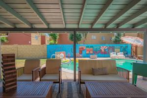 a patio with chairs and a pool with a playground at Near Mntn Park Private Pool & Fully Fenced Yard in Phoenix
