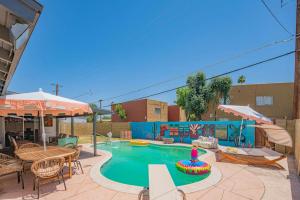 a swimming pool with a table and chairs and an umbrella at Near Mntn Park Private Pool & Fully Fenced Yard in Phoenix +97 photos