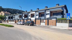 a building with cars parked on the side of a street at Casa vacacional Saelia in Ribadesella