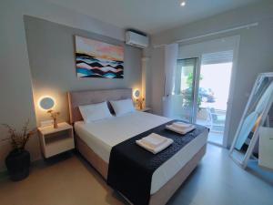 a bedroom with a bed with two towels on it at mesogios enjoyable living in Kallithea Halkidikis