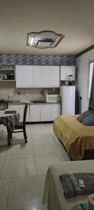 a kitchen with two beds and a table in a room at Studio Centro Floripa 05 in Florianópolis