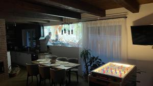a dining room with a table with chairs and a television at Evelin, Slovakia in Habovka
