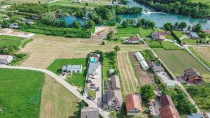an aerial view of a farm with a train in a field at Delta apartments in Bihać