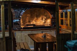 a brick oven with a wooden table in front of it at Delta apartments in Bihać