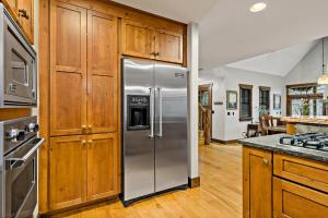 a kitchen with wooden cabinets and a stainless steel refrigerator at Stepping Stone in Black Mountain