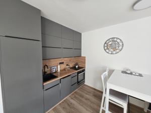 a kitchen with a counter and a table and a refrigerator at Apartmán Maršovák Horní Maršov in Horní Maršov