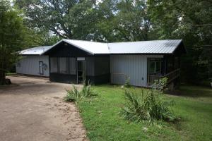 a small house with a garage in a yard at White River Float Trips - Charming country 4Bd 2Ba Full House - Near Beaver Lake & Dam and Eureka Springs - 3 boat ramps within 3 miles in Eureka Springs