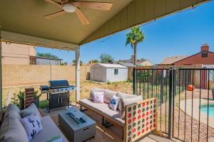 a patio with a couch and a fire place at Private Pool & Fully Fenced Yard Near Mntn Park in Glendale